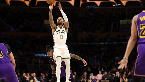 Milwaukee Bucks guard Damian Lillard (0) shoots the ball against Los Angeles Lakers guard D'Angelo Russell (1) during the first quarter at Crypto.com Arena. 